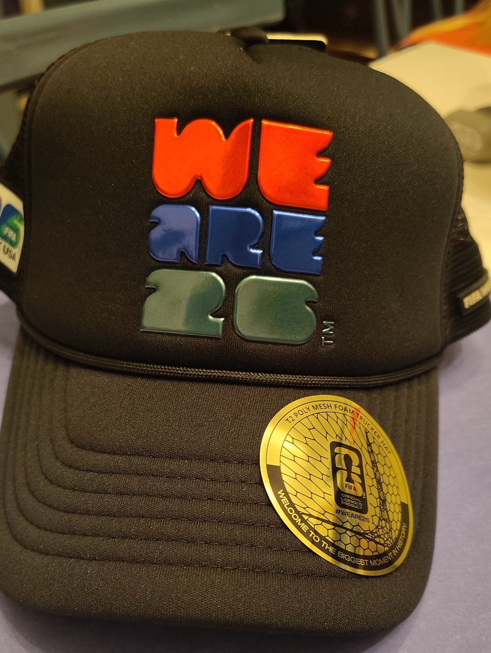 WE ARE 26 Black Foam Trucker Hat by FIFA